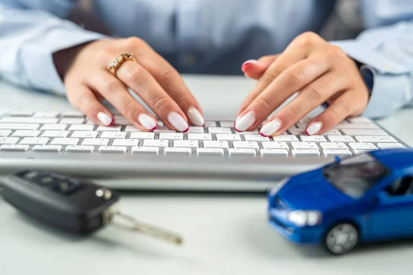 Car dealerships offer car ownership contracts at interest rates in their offices. Desktop. Keyboard with car model
