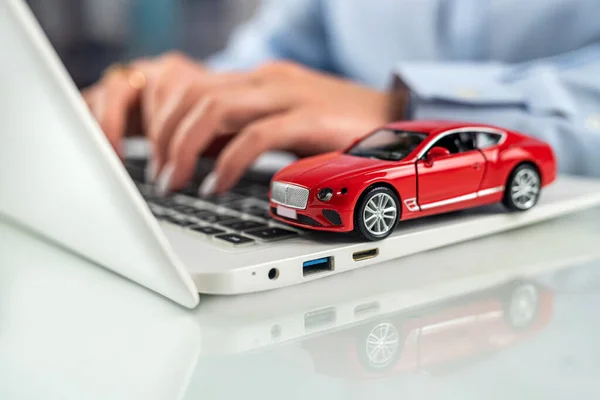 Car dealerships offer car ownership contracts at interest rates in their offices. Desktop. Keyboard with car model