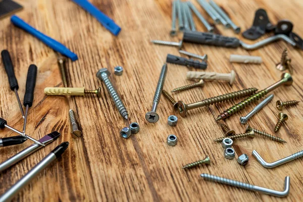 stock image Lots of self-tapping screws and nails and construction screws and metal and plastic drywall anchors. Repair and tools for it