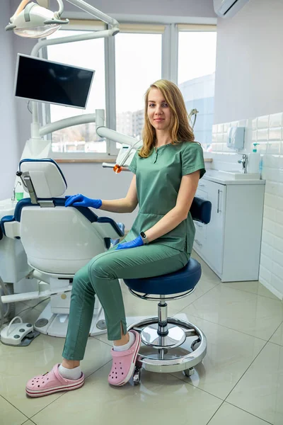 young female dentist in private clinic with modern dental equipment. health care