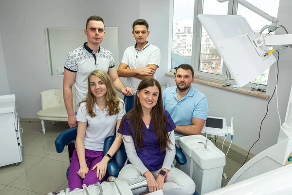 beautiful young people experienced in medicine who love to treat teeth posing for a portrait. Concept of happy dentists on portrait