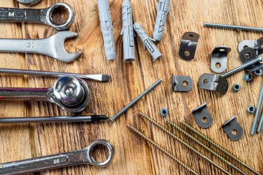 Mobilya montaj aletleri, tahta masa dokusuna vida anahtarı ve cıvata yerleştirilmiş. Mobilya montajı kavramı