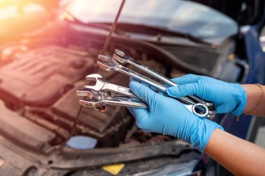 Araba tamircisi bir arabayı tamir etmek için garajda çalışır. Onarım hizmetleri.