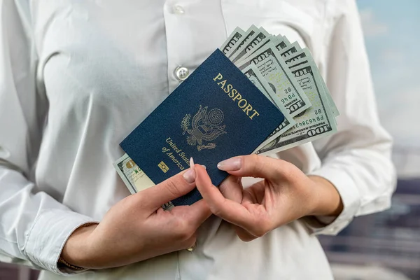 female flight attendant with money dollars and american passport in tourist hand holding. the concept of passport control. travel crossing the border