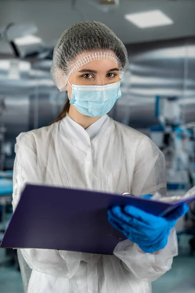 female doctor in white coat showing blank clipboard to write to record patient\'s diagnosis in clinic room. operating room medicine. doctors surgeons Healthy Lifestyle