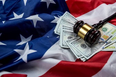 the gavel is placed together with dollars on the background of the flag of the United States of America. symbol of jurisdiction. Bribes in the justice system of the country
