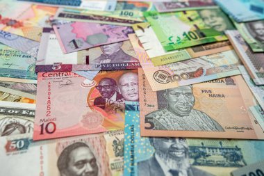 close-up of African currency of various colors shapes and denominations filled the entire table. trade. banknotes of different denominations. Africa