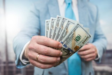 business man accounting stack of dollar money, finance or corruption concept