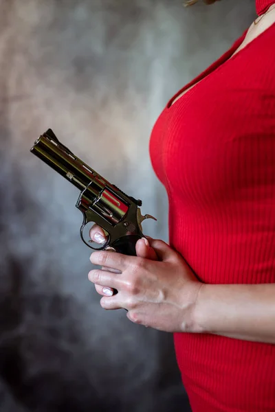 female spy agent wear red dress with handgun isolated, crime concept