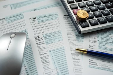 US individual income 1040 tax form with US coin and calculator, finance taxation concept