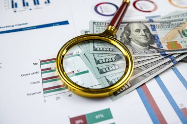 Business graph graphs paper with us dollar bills and magnifying glass. Analytic research data economy