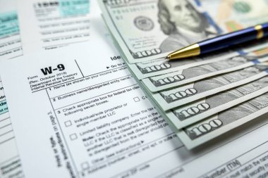 blank tax return form 1040 with dollar banknote. Deadline business finance concept
