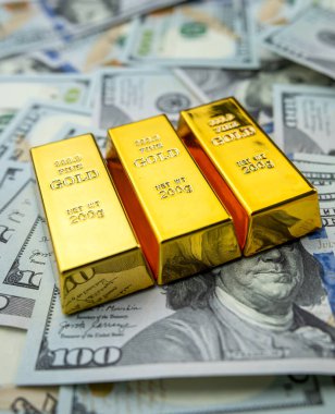 100 dollar bills with gold bars bullions. Wealth saving concept