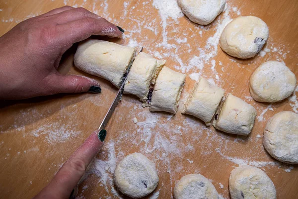 stock image Female hands cut with knife raw sweet dough, the process of making cheesecakes. Cooking food 