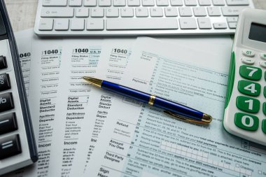 paperwork and deadline tax form 1040 with keyboard as online work. financial concept 