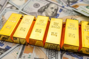 100 dollar bills with gold bars bullions. Wealth saving concept