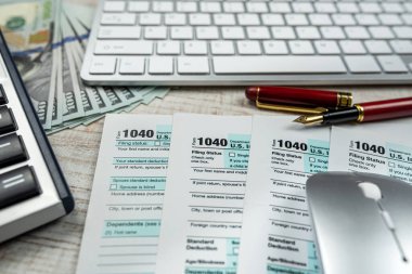 blank tax return form 1040 with dollar banknote. Deadline business finance concept