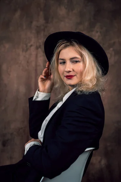 Portrait of a beautiful Caucasian business woman in a modest suit on a single background. female portrait. isolated on dark background