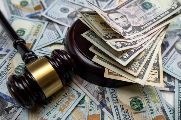 stock image judge gavel and 100 dollar bills as background. Judge and money concept. Corruption