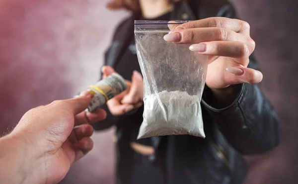 stock image woman addict paying dollar money to drug dealer to buy dose of white powder cocaine. Money exchange for drugs. Drug abuse and traffic concept. 