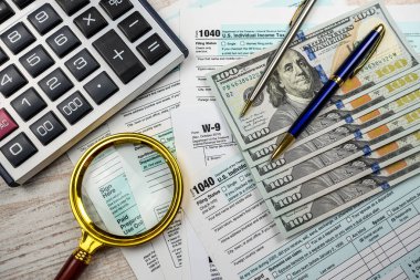 2022 boş 1040 vergi formu ve dolar büyüteç. Evrak işleri, finansal konsept teslim tarihi