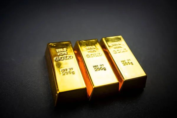 Gold bars isolated on black background. Finance and saving value concept