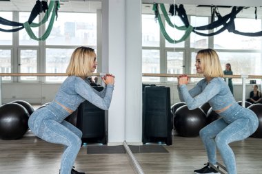 stretching on training of a young woman in the gym to improve her body. fitness sport. training. gym. lifestyle concept.