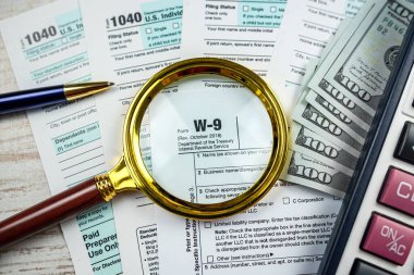 2022 blank 1040 tax form with us dollar magnifying glass. Paperwork, financial concept deadline