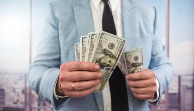 business man accounting stack of dollar money, finance or corruption concept