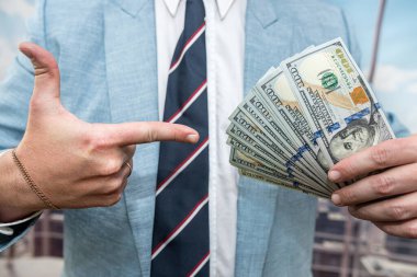 young man in a suit counts the money, finance conept. close up