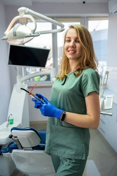 young female dentist in private clinic with modern dental equipment. health care