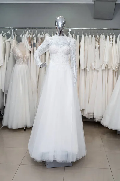 Beautiful white wedding dress on mannequin in trendy bridal show room