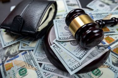 Amerikan dolarlarının arka planında bornozlu bir adamın adli tahtadan tokmağı izole edilmiş. Küçük bir odak. Yargıçlara rüşvet verme yetkisi. Hükümetin yargı organına rüşvet