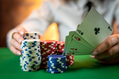 woman who knows how to play poker perfectly sits at a poker table with cards and chips. money game concept. isolated on plain background