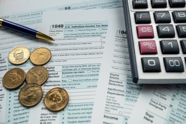 closeup blank Tax return form 1040 with us coin cent. Accounting concept