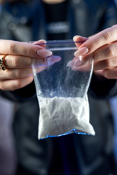 Packet with cocaine narcotic powder in female dealer, crime concept. Danger addiction overdose concept.