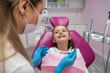 small beautiful patient came to the children's state-of-the-art dentistry for an oral examination. the concept of a healthy oral cavity