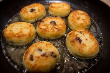 fresh tasty cheese pancakes cheesecakes are fried in a pan, ukraine traditional food. Homemade