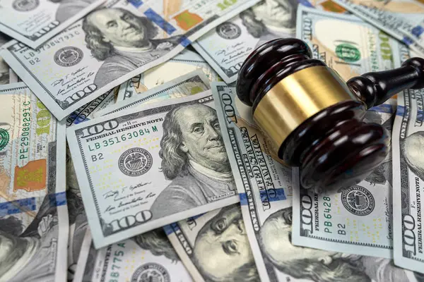 large amount of dollar money and a judge\'s gavel on the table isolated. Trial and bribery. corruption in higher authorities