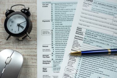 1040 tax form pen with calculator and alarm clock. Annual tax payment 