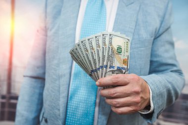 Erkek eli yakın çekim dolar sayar. Yatırım nakit ve maaş kavramı