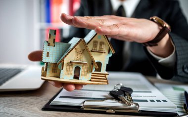 Real estate agent  work with documents for dsle property. Concept of home insurance and investment loan