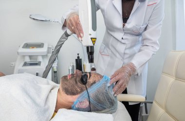 Güzellik uzmanı ya da cildiyeci müşterinin yüzüne beyaz bir maske takar. Güzel bir kadın güzellik salonunda yalan söyler ve dinlenir. Kırışıklık önleyici kozmetik prosedürler yüzü nemlendirir..