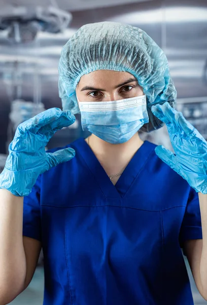 stock image close-up of a tired nurse removing surgical mask. Concept of end lockdown for coronavirus. Female doctor after a shift in the hospital