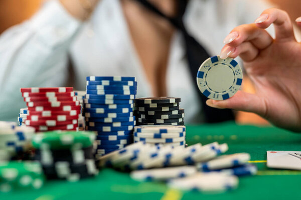 girl in poker has won everything and takes all the chips with her own hands. Playing casino or poker. focus on the chips. Raising rates or gambling business. isolated