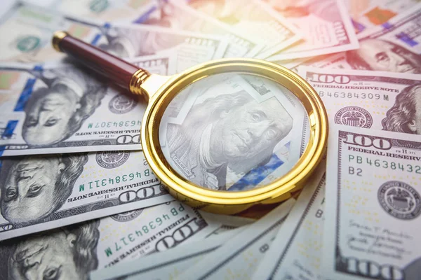 stock image us dollars and a gold magnifying glass closeup, finance conept. Money and financial 