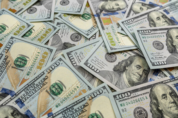 Pile of new 100 dollar banknotes bills on black. Finance concept. Rich and saving