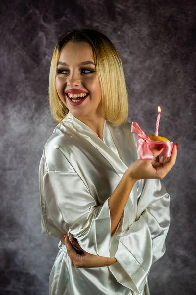 Young Woman Beautiful Light Silk Robe Holding Cupcake Candle Isolated — 스톡 사진