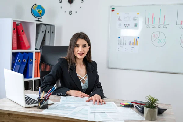 stock image Caucasian businesswoman in suit filling 1040 form of individual income tax return at modern office. Paperwork, annual report