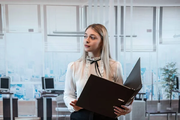 stock image Attractive business woman posign alona t office and hold folders for papers document. 